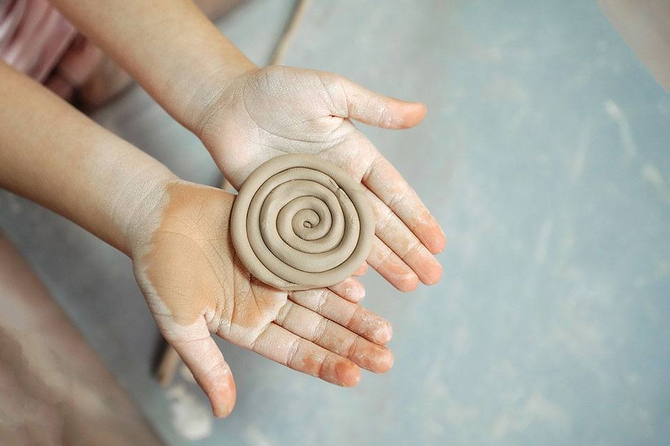 two open hands holding claw formed into a circle